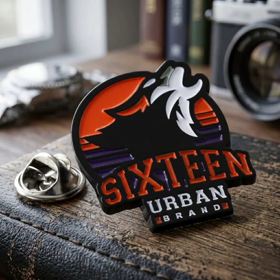 Black, orange and white wolf-head enamel badge with clutch backing
